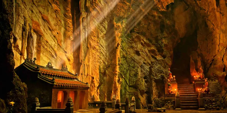 Dark cave with mystical Troglodyte temple, Huyen Khong grotto, Marble Mountains