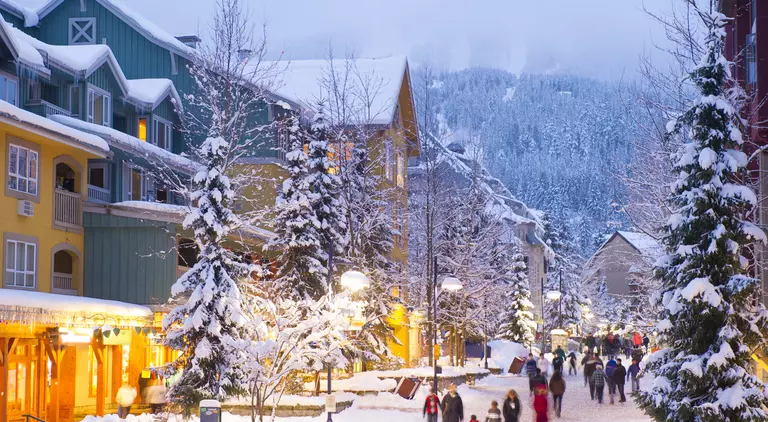 Stunning pedestrian village blanketed with fresh snow at dusk at twilight