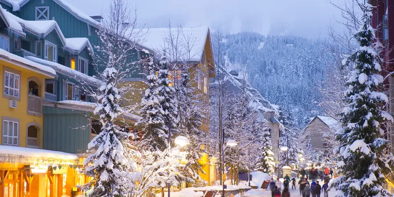 Stunning pedestrian village blanketed with fresh snow at dusk at twilight