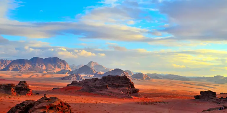 Sunset over rock formations and red desert
