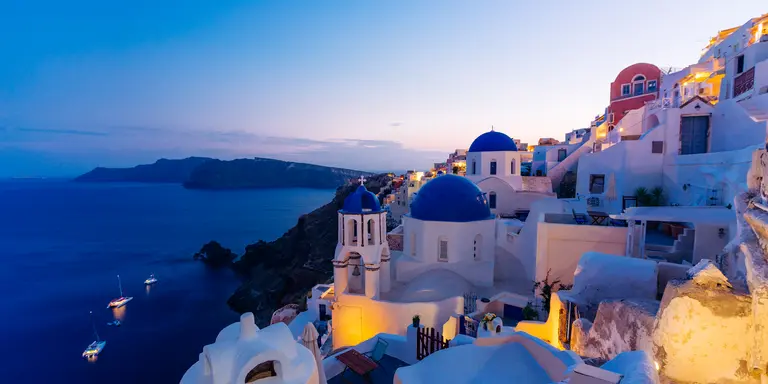 Famous Oia blue dome churches at twilight