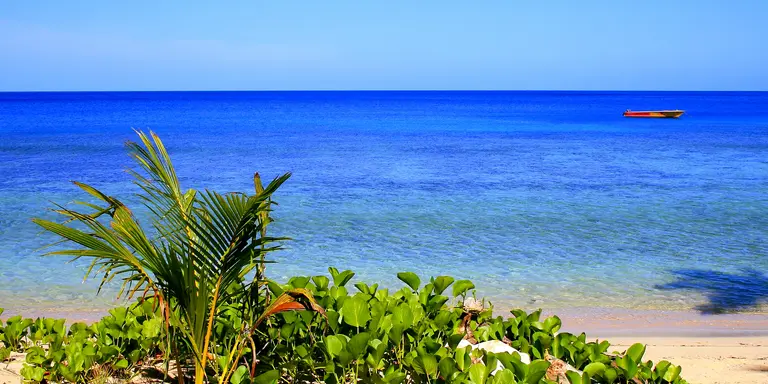 Turquoise pacific ocean waters and boat
