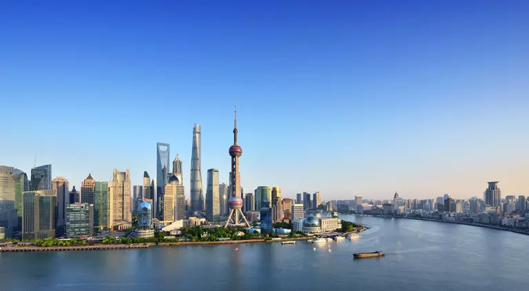 Shanghai skyline in blue sky at sunset