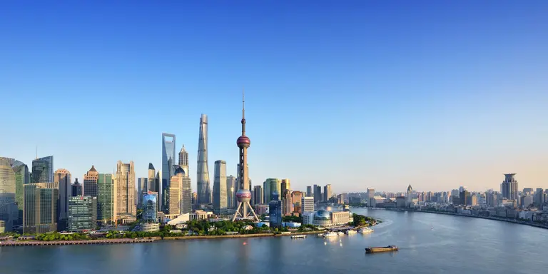 Shanghai skyline in blue sky at sunset