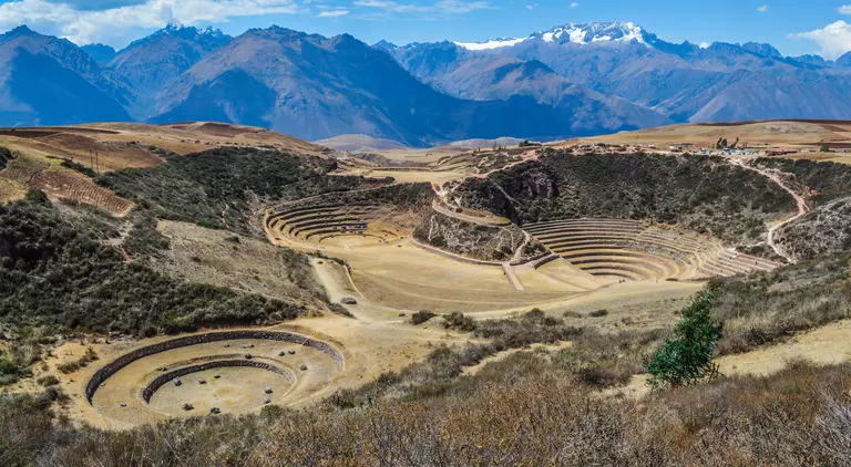 Ancient Inca circular terraces with Andes mountains in the background