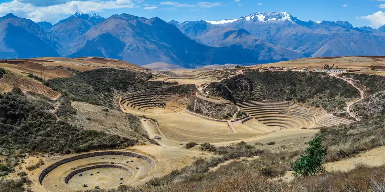 Ancient Inca circular terraces with Andes mountains in the background