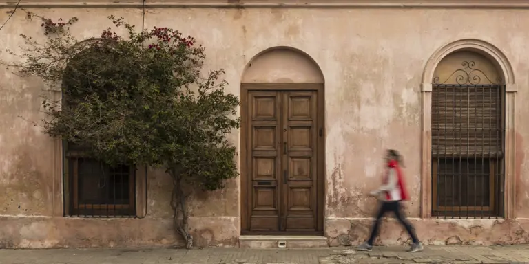 Long exposure image of a woman walking on the streets in the historic district of Colonia del Sacramento in Uruguay