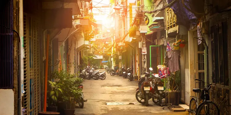 Motor bikes lined down narrow street of Ho Chi Minh city, Vietnam