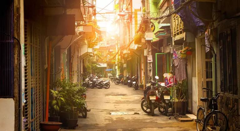 Motor bikes lined down narrow street of Ho Chi Minh city, Vietnam