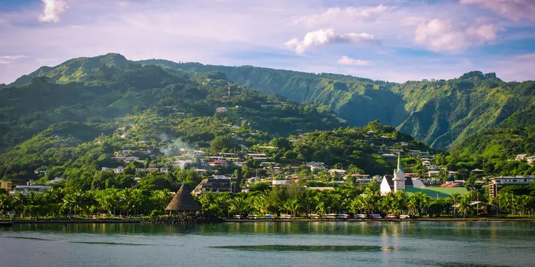 Landscape of Tahiti with mountains and village close to the port of Papeete, French Polynesia