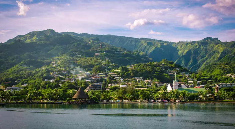 Landscape of Tahiti with mountains and village close to the port of Papeete, French Polynesia