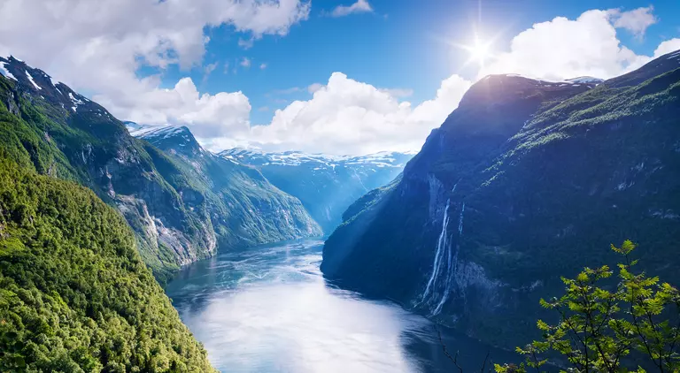 View of the old mountain farm and the famous waterfall overlooking the stunning fjord