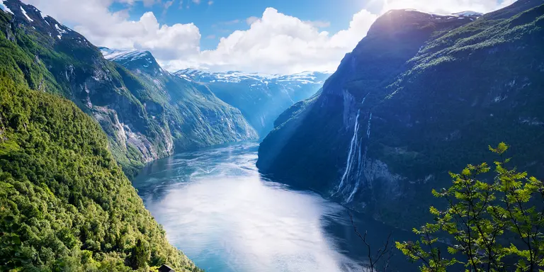 View of the old mountain farm and the famous waterfall overlooking the stunning fjord