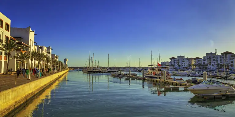 marina with boats and old buildings along the sea