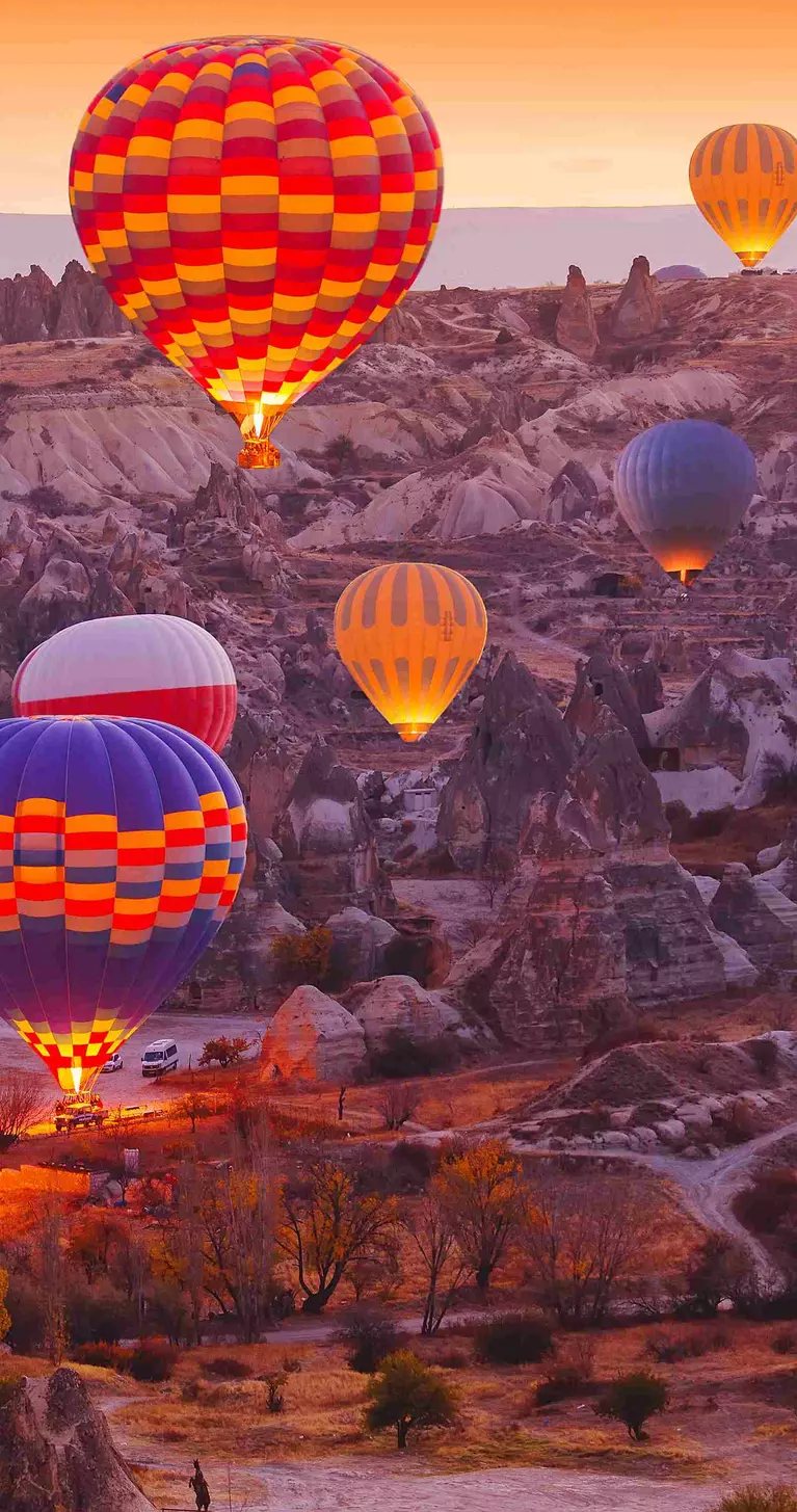 Scenic vibrant view of balloons in flight in Cappadocia Valley