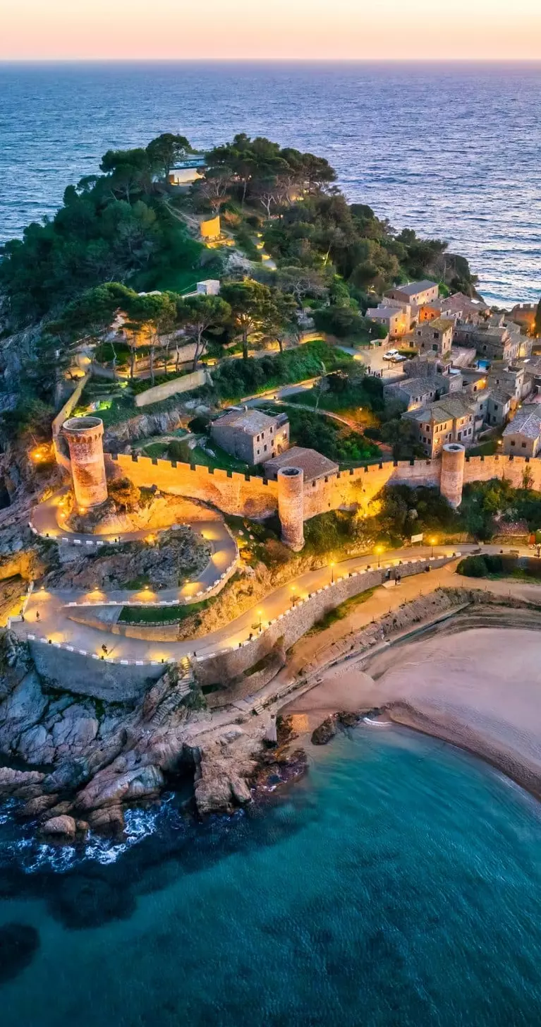 Aerial view of walls of Tossa de Mar in Costa Brava, Catalonia at sunset, Spain