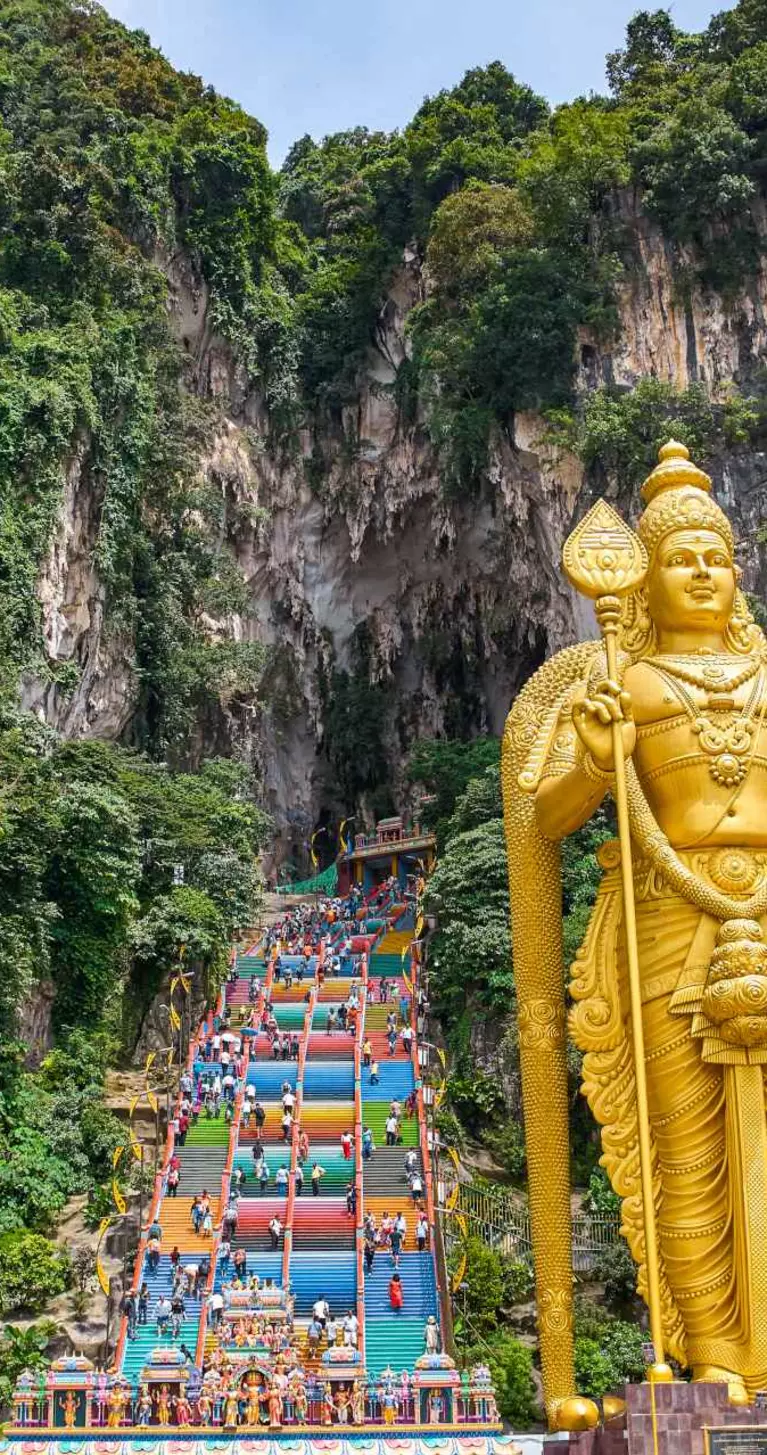 272 colorful stairs lead up to the Batu Caves with the Lord Murugan Statue, 42m tall, in the foreground