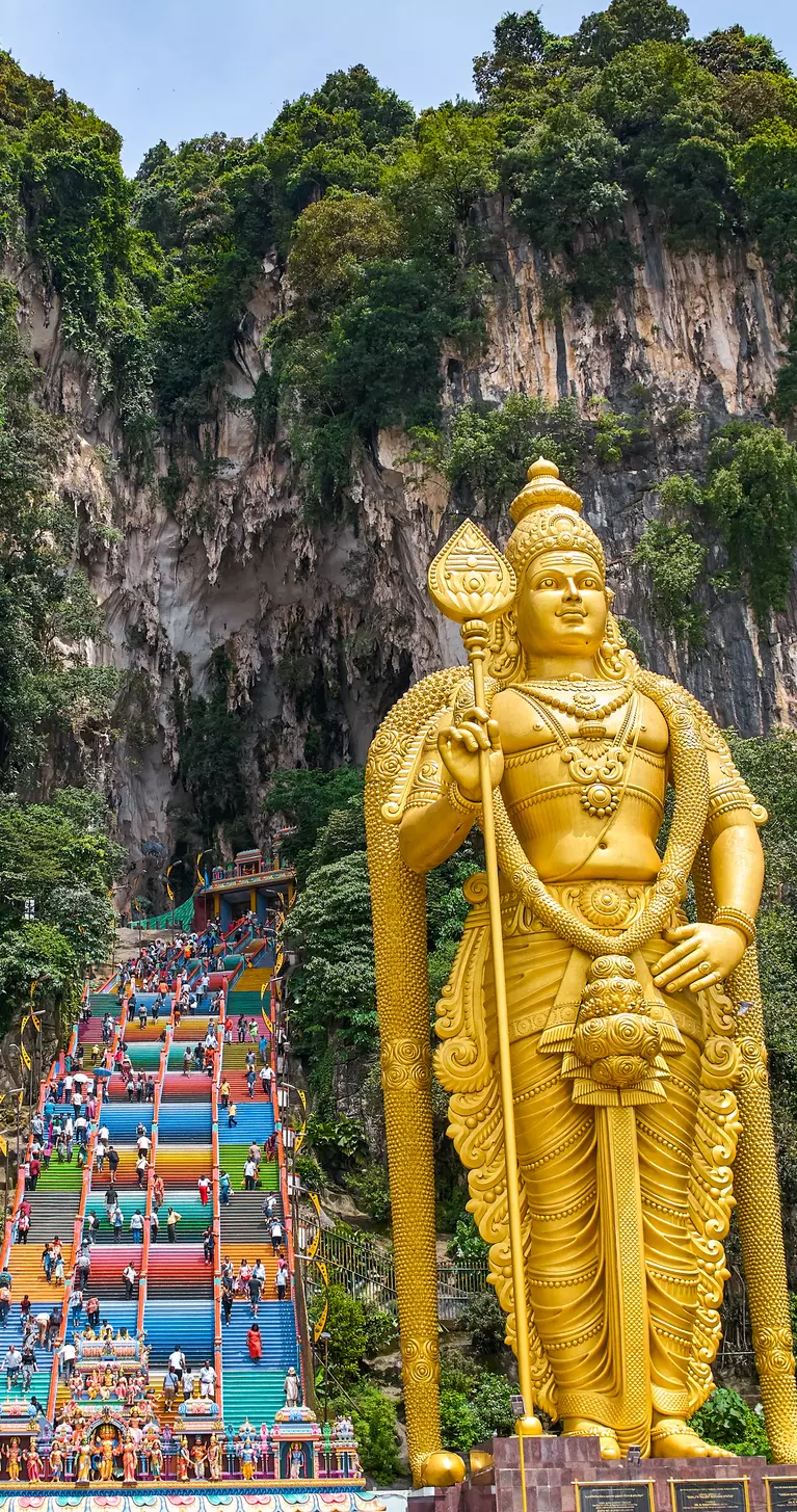 272 colorful stairs lead up to the Batu Caves with the Lord Murugan Statue, 42m tall, in the foreground