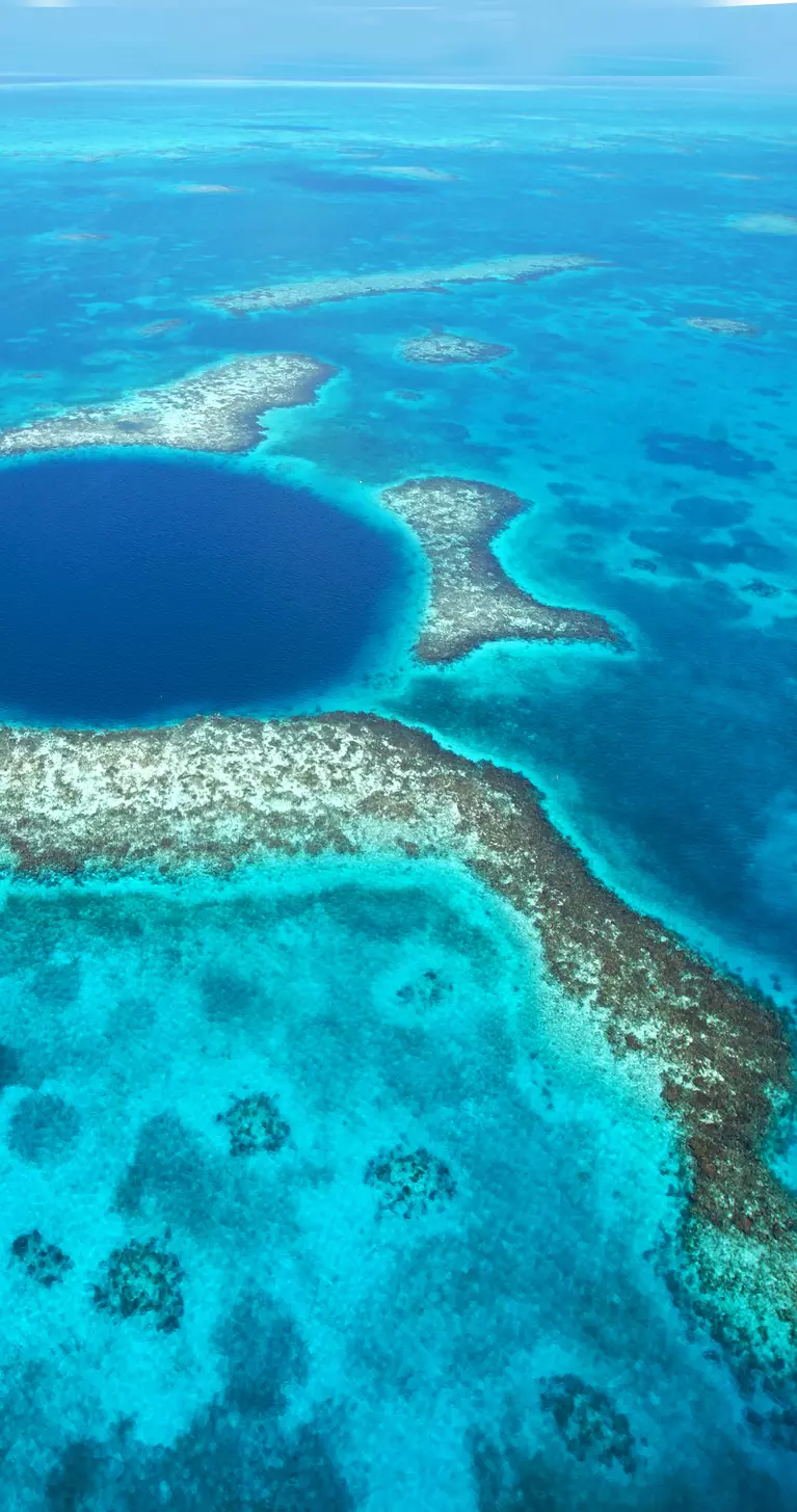 Great Blue Hole is a natural sinkhole off the coast of Belize that measures roughly 1,000 feet across and 400 feet deep
