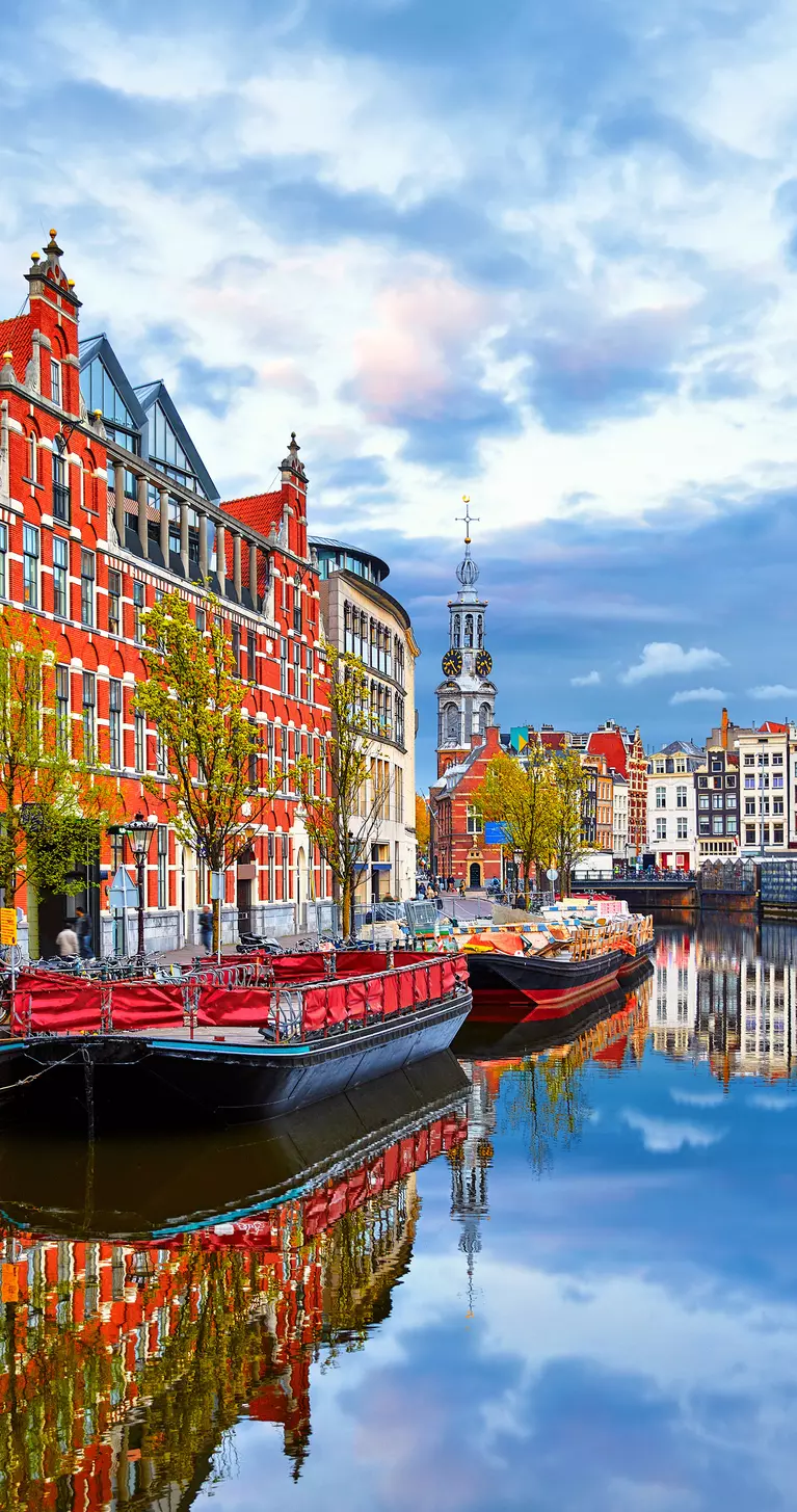 Channel in Amsterdam Netherlands houses river Amstel landmark old european city spring landscape.