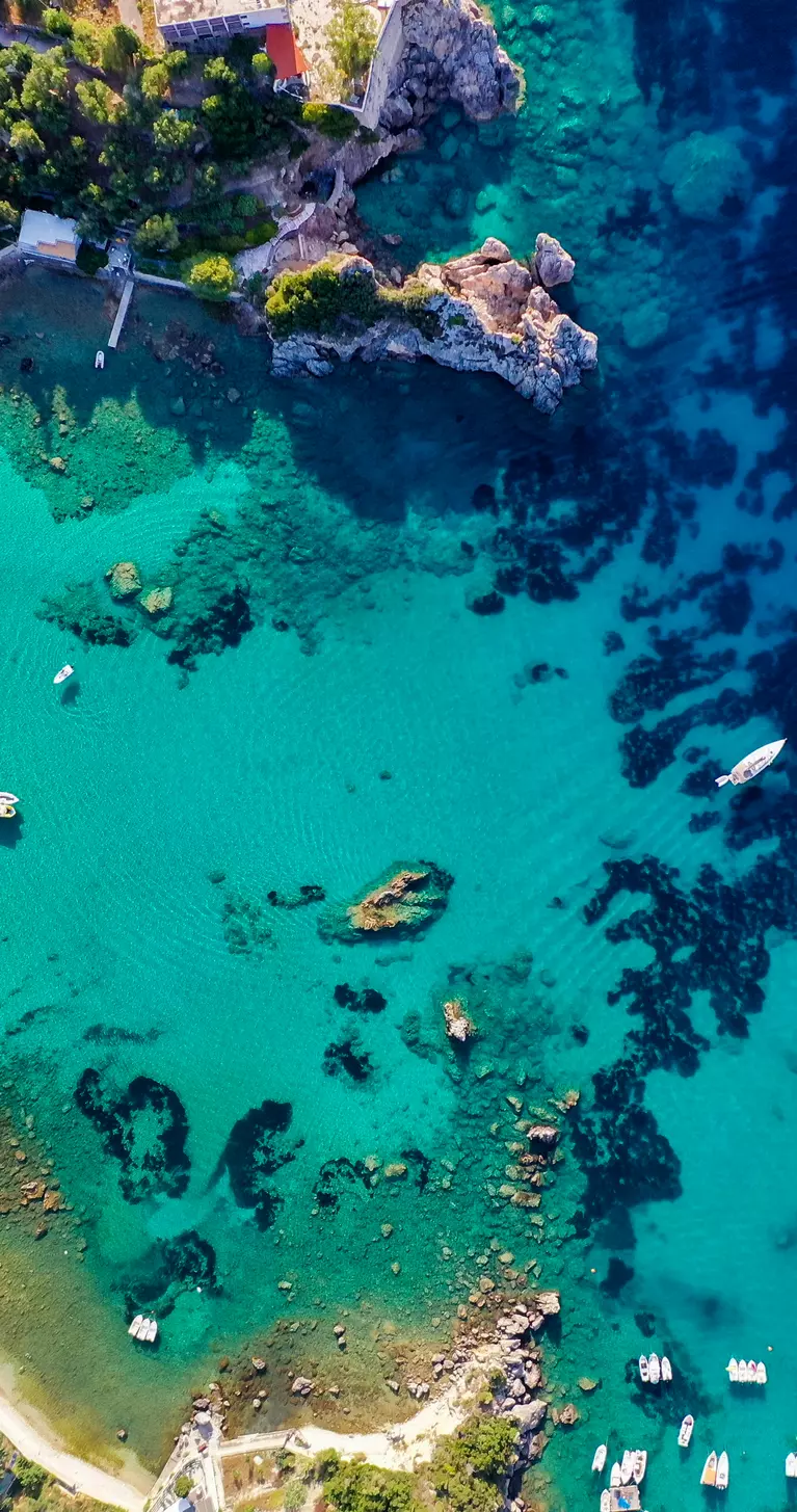 Aerial view of the beautiful Corfu coastline, showing deep blue colours of the Mediterranean Sea