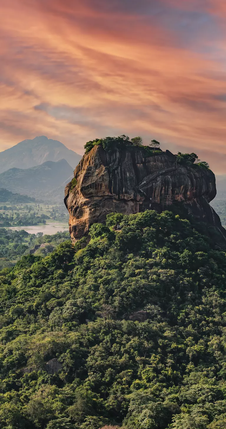 "View of the Lion rock surrounded by green rich vegetation, photo taken from Pidurangala Rock in Sigiriya, Sri Lanka. "