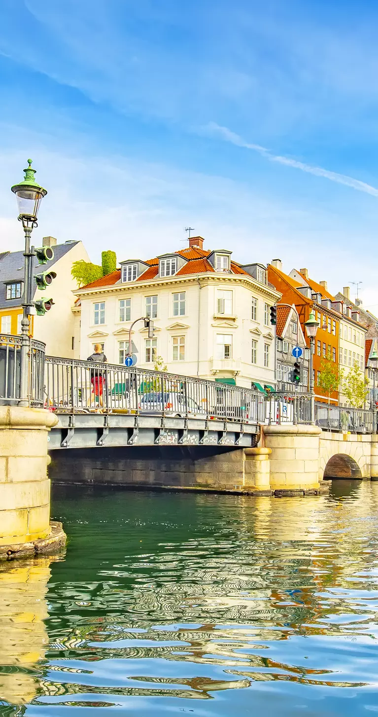 Coloful houses sit on the canal of the old town skyline in Copenhagen