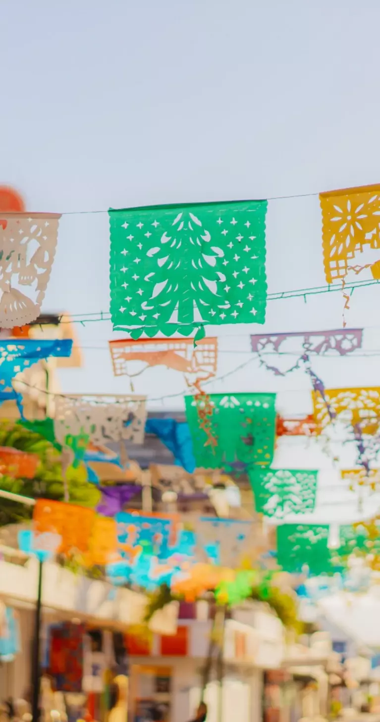 Colourful flags are waving on a shopping street in Mexico