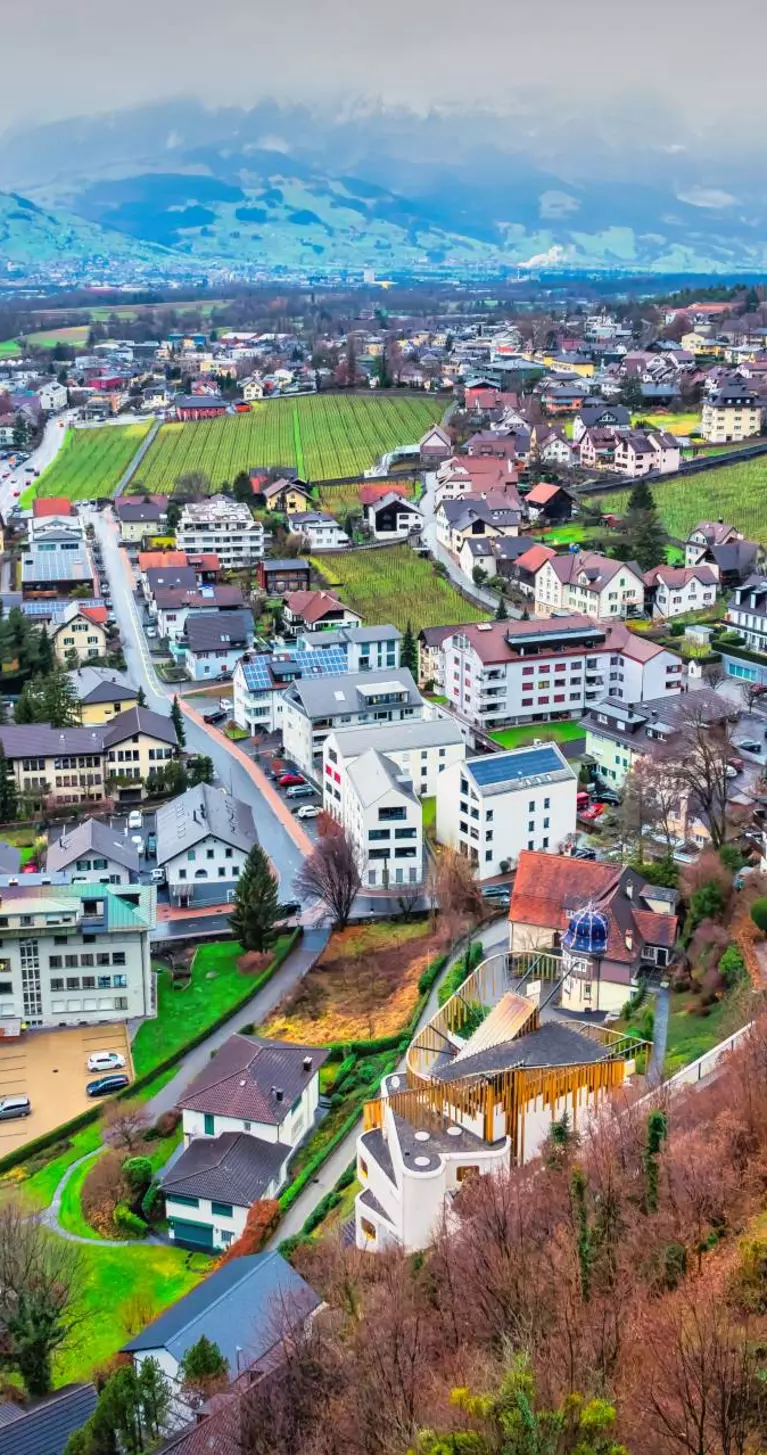 Aerial view of the cityscape of downtown Vaduz, Liechtenstein on an overcast day.