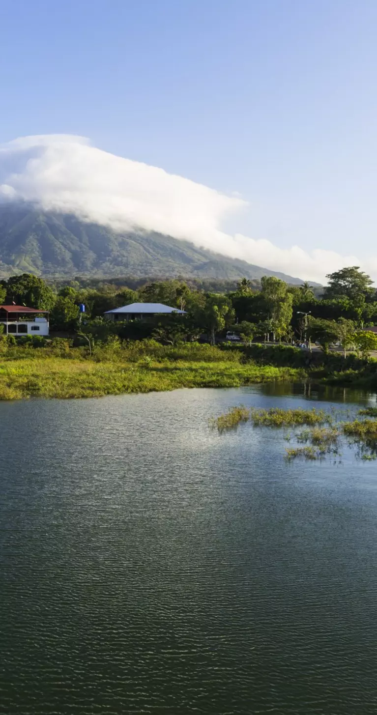 Morning view from Lake Nicaragua to island Ometepe and volcano Concepcion with white clouds on it