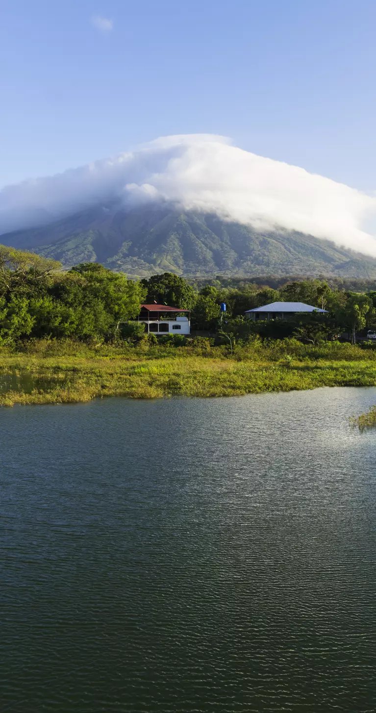 Morning view from Lake Nicaragua to island Ometepe and volcano Concepcion with white clouds on it