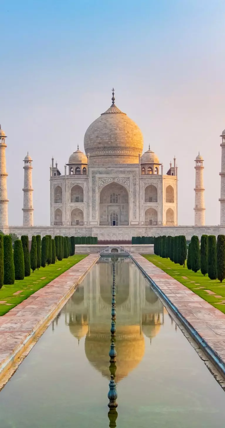 Taj Mahal front view reflected on the reflection pool, an ivory-white marble mausoleum Agra, Uttar Pradesh, India. One of the seven wonders of the world