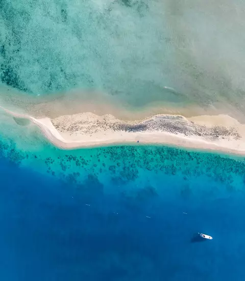 High angle aerial drone view of the sandbar and blue waters