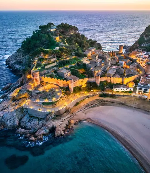 Aerial view of walls of Tossa de Mar in Costa Brava, Catalonia at sunset, Spain