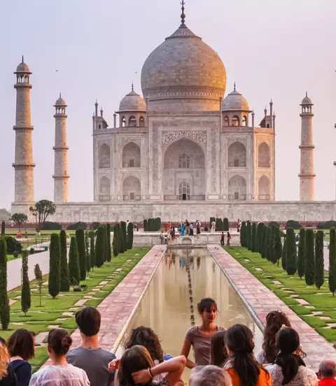 Group of tourists visit the landmark Taj Mahal in Agra, India