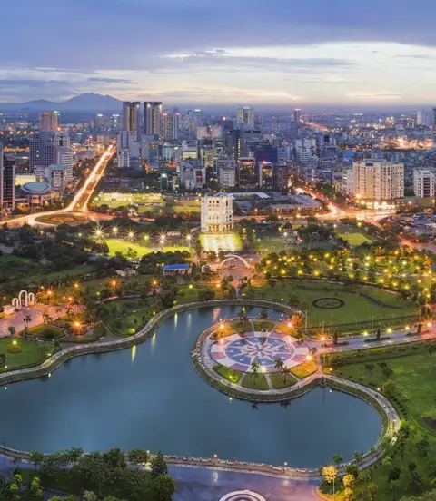 Hanoi skyline cityscape at twilight period, with Cau Giay Park in foreground