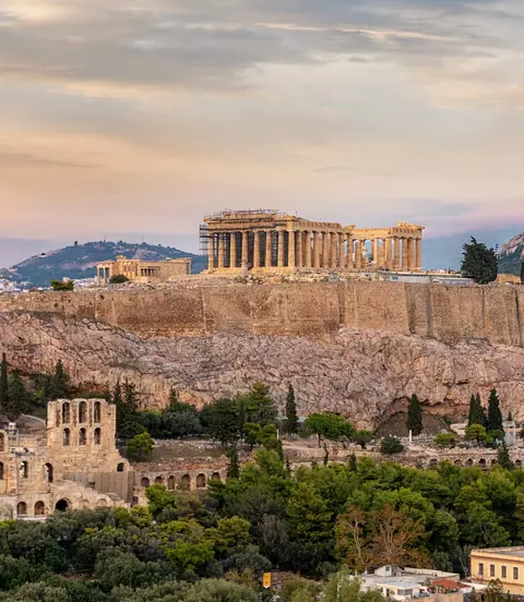 View to the Acropolis of Athens on top of the old town Plaka during a cloudy summer sunset, Greece