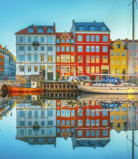 View of clear waters reflecting the buildings of Nyhavn along the canals of Copenhagen, Denmark