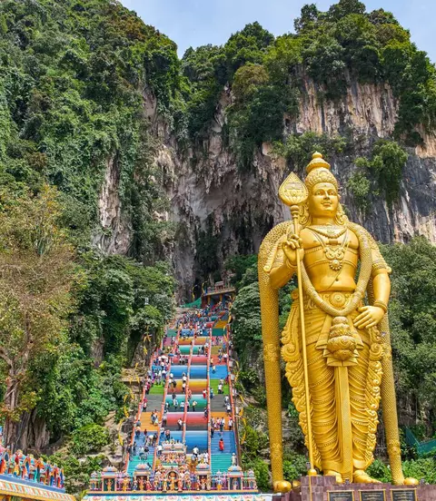 272 colorful stairs lead up to the Batu Caves with the Lord Murugan Statue, 42m tall, in the foreground