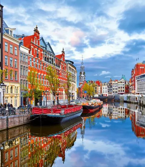 Channel in Amsterdam Netherlands houses river Amstel landmark old european city spring landscape.