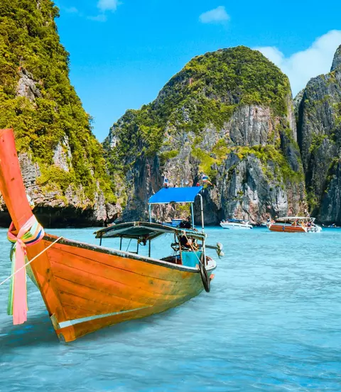 Wooden Cutter Longboat Moored in water with hills and island behind