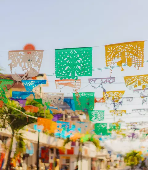 Colourful flags are waving on a shopping street in Mexico