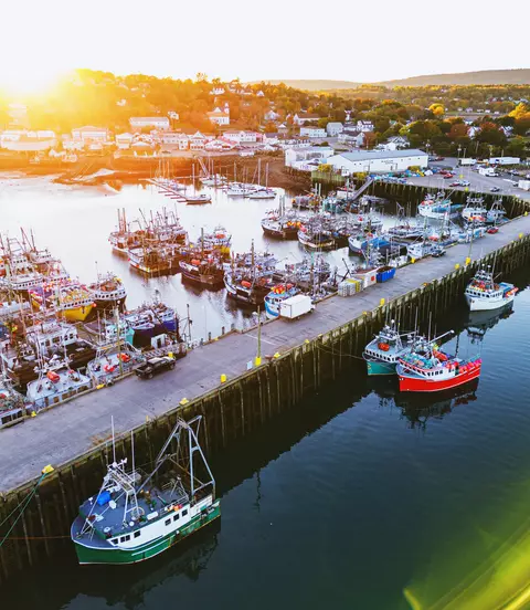 Aerial drone view of a small town fishing wharf just before sunset.