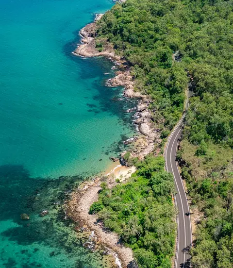 Aerial view of the Captain Cook Highway where the rainforest meets the reef in tropical Far North Queensland, Australia