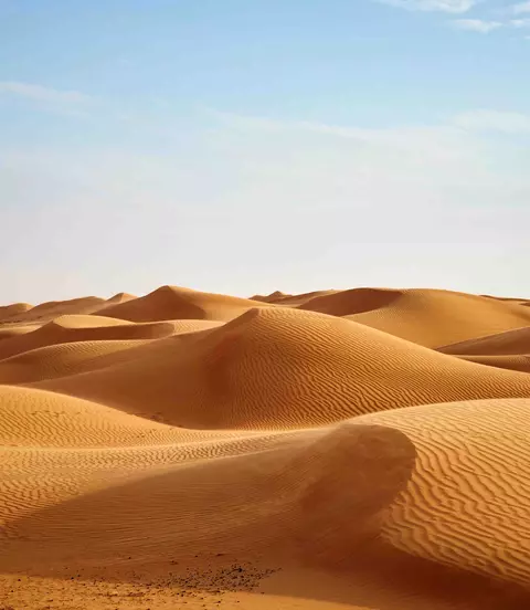 Wind blowing on the desert sand dunes of Oman