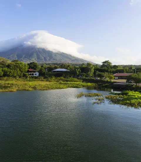 Morning view from Lake Nicaragua to island Ometepe and volcano Concepcion with white clouds on it