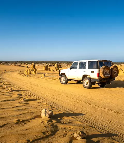 Four-wheel-drive car in the Pinnacles Desert, Nambung National Park, Western Australia.