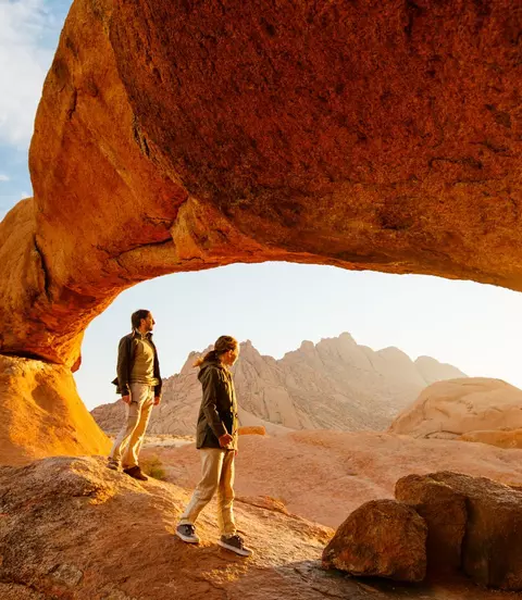 sunrise red rock people hiking