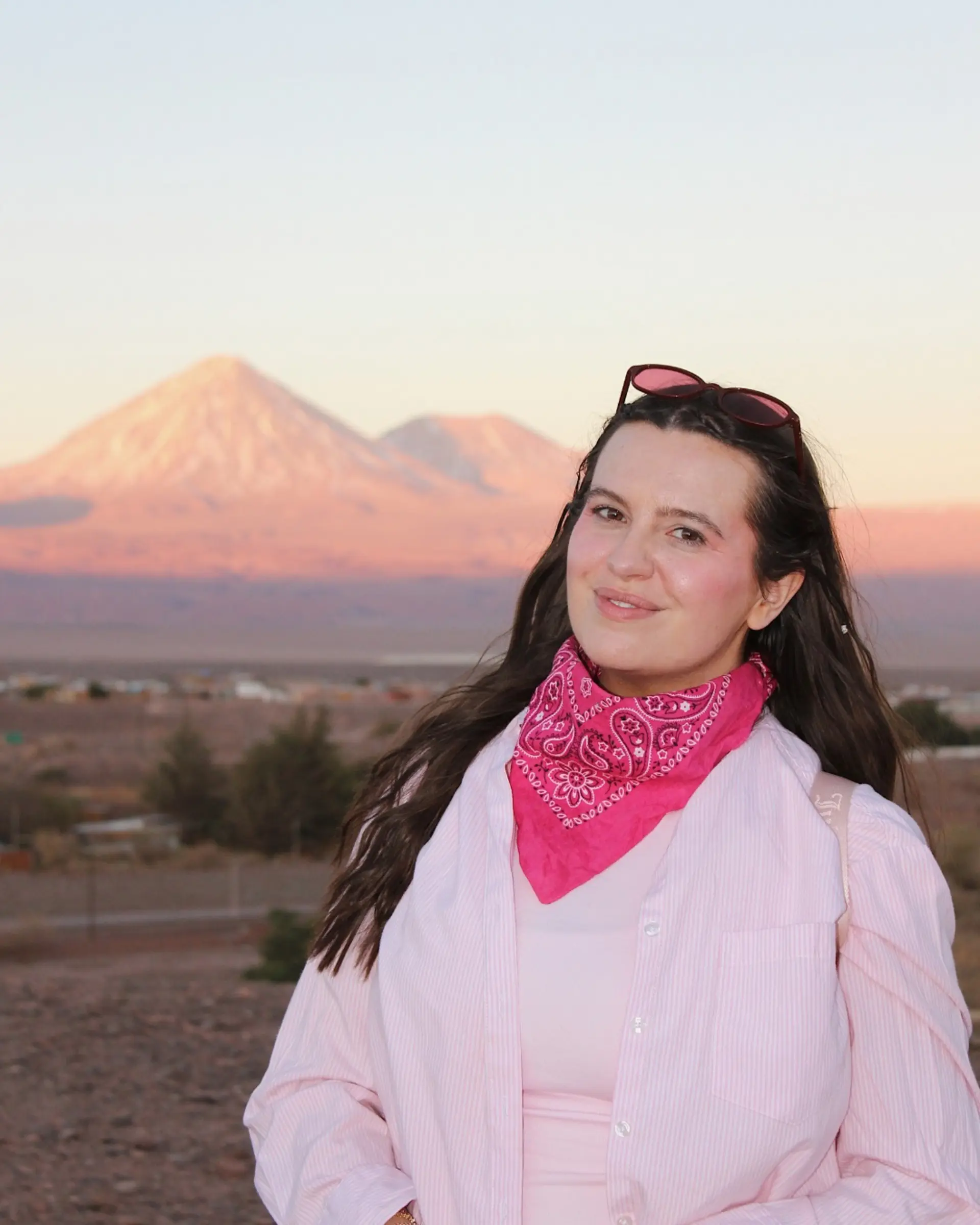 Globetrotting Content & Creative Manager Mikayla at sunset with the Licancabur volcano behind her in San Pedro de Atacama, Chile