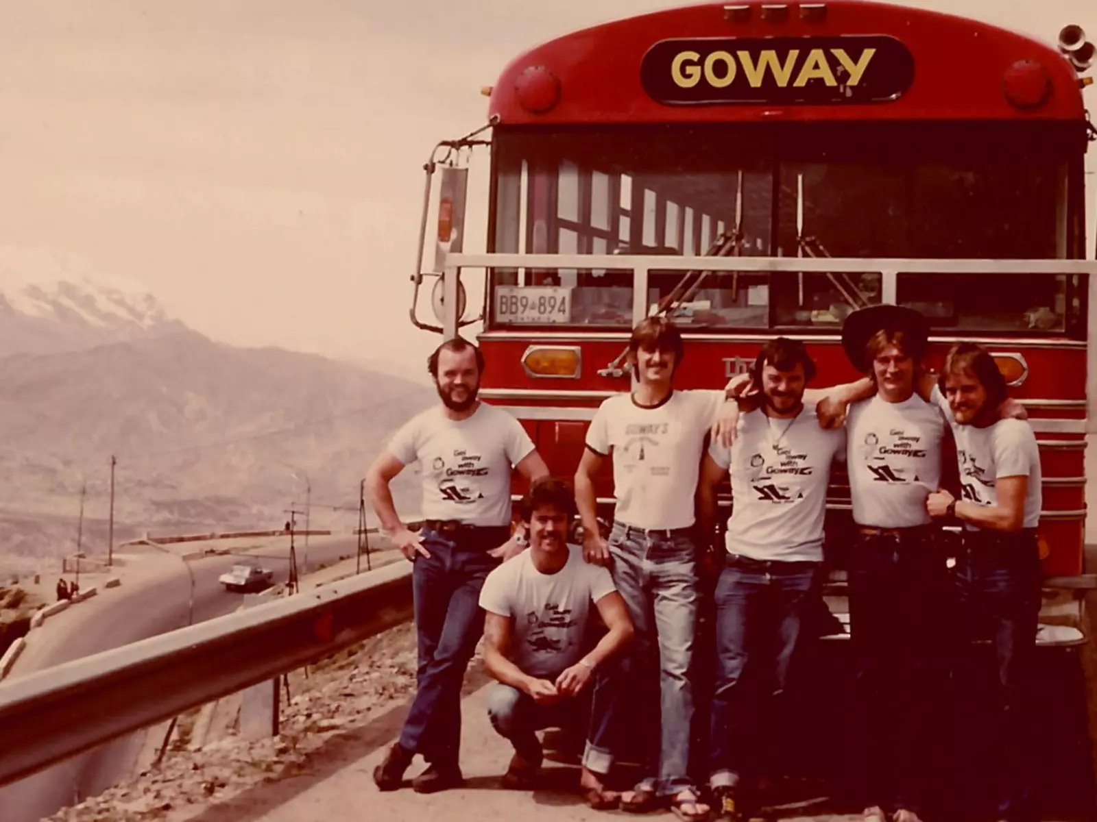 Goway team members pose in front of their bus.